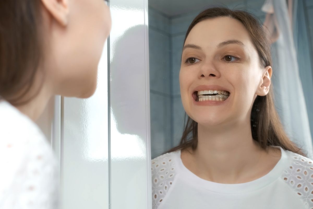 Woman smiling with dental retainers