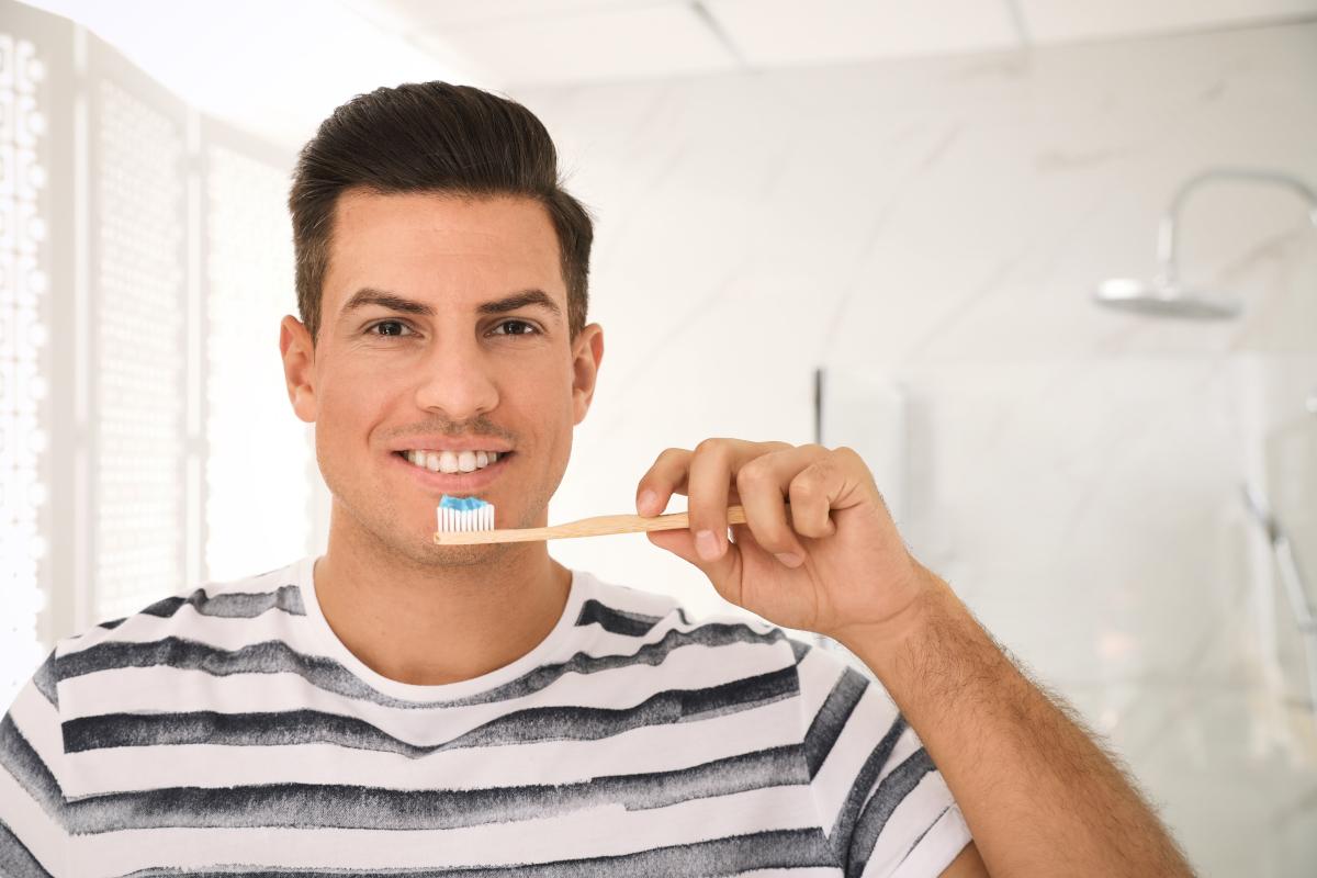 Man,Holding,Toothbrush,With,Paste,In,Bathroom What is Fluoride