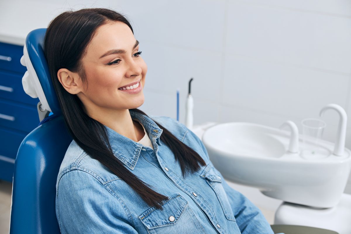 How Dry Mouth Affects Your Smile Smiling woman relaxing in dental chair at modern dental office